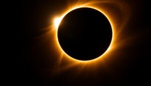 Total solar eclipse with corona visible against dark sky, natural phenomena tourism